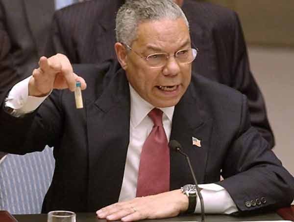 Colin Powell holding a model vial of anthrax while giving a presentation to the United Nations Security Council